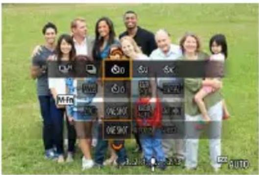 Group photo of people holding a smartphone with labeled buttons and a red 'ONE SHOT' button, likely for a mobile phone or app interface.