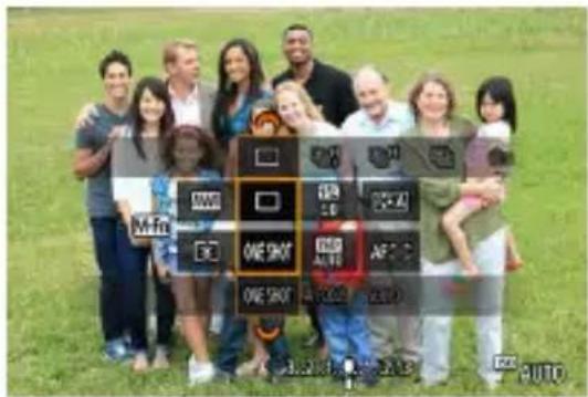 Group photo of people holding a smartphone with labeled buttons and icons, including 'ONE SHOT' and 'AUTO'
