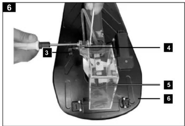 Labeled diagram of a device interior with numbered parts, showing a hand holding a tool near a mechanical component.