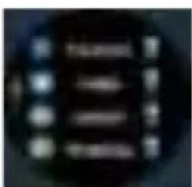 Blurred image of a dark circular object with indistinct white text and symbols, possibly a label or icon.