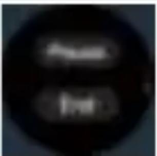 Cropped image showing two blurred, dark circular shapes with indistinct white text.