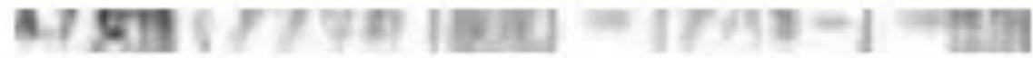 Blurred image with indistinct text and a red circular emblem, likely from a document or sign.