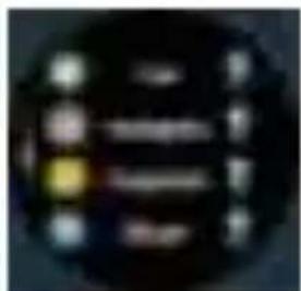 Blurred image of a dark circular object with indistinct white text and yellow highlight, possibly a label or icon.