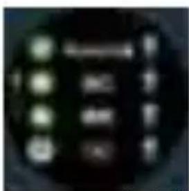 Close-up of a dark circular device with illuminated buttons and display screen showing text and symbols