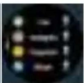 Blurred image of a dark circular object with indistinct white and yellow symbols, possibly a UI element or control panel.