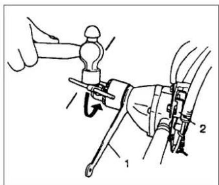 Technical diagram showing mechanical assembly with labeled parts 1 and 2, including a hand holding a tool.