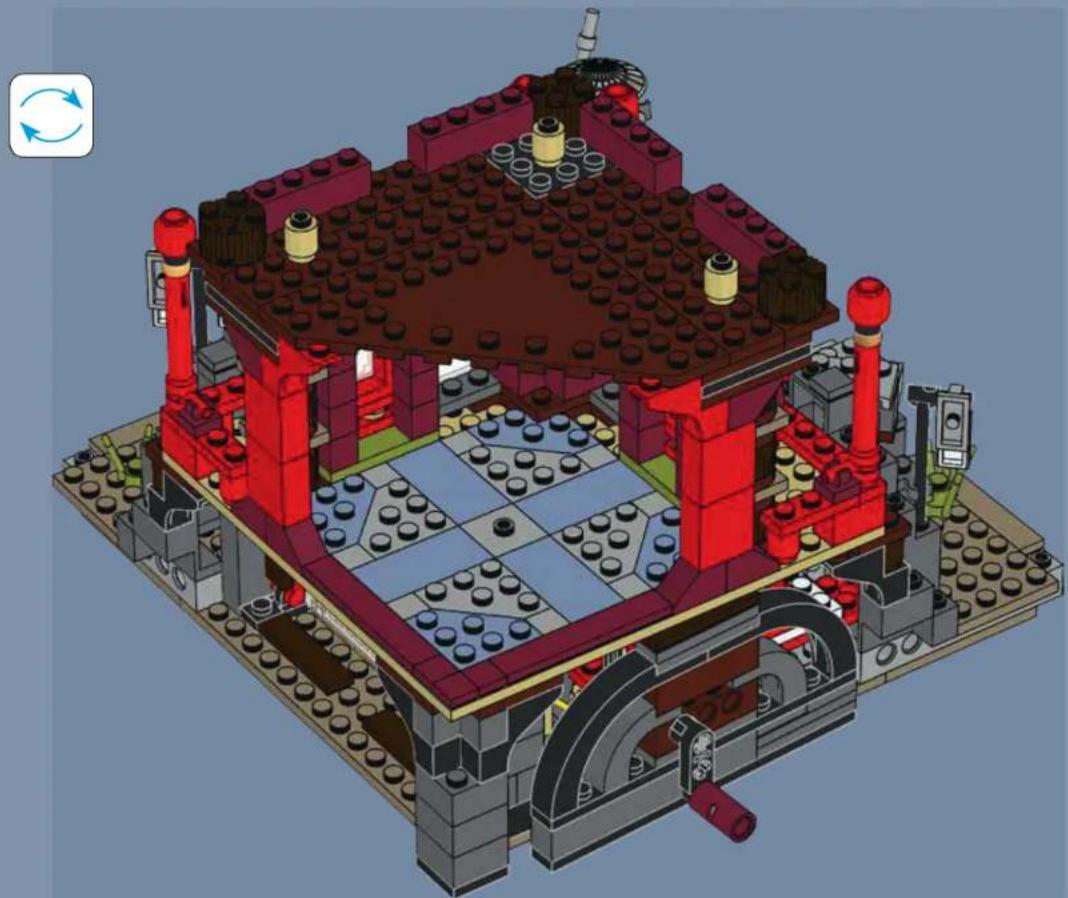 3D architectural model of a LEGO building with red and blue components, featuring a central courtyard and surrounding structures (no text or symbols visible)