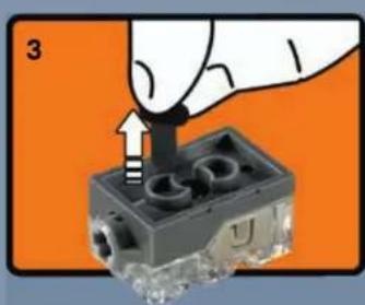 Hand inserting a plug into a small electronic component (no text or symbols visible)