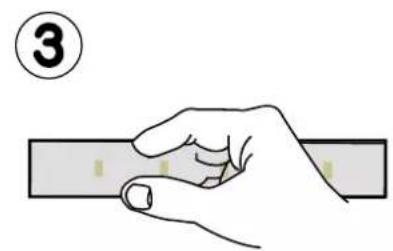 Illustration of a hand holding a rectangular object with a numbered circle (3) above, no text or symbols present.