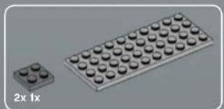 3D illustration of a small rectangular block with four rounded pins and a grid of circular indentations on top (no text or symbols)