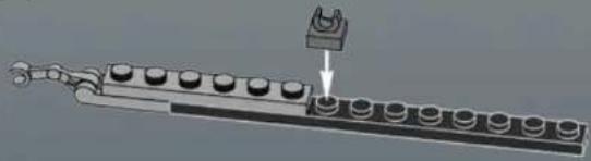 Mechanical assembly diagram showing a chain with multiple circular components and a U-shaped component inserted into a housing (no text or symbols)