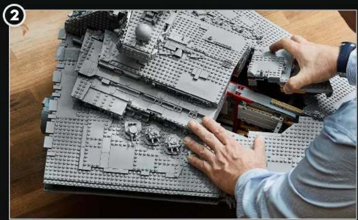 Person assembling a LEGO building model on a wooden table (no text or symbols visible)