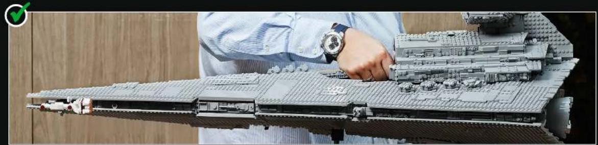 Person assembling a detailed LEGO rocket model (no visible text or symbols)