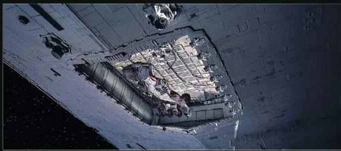 Astronauts living on a spacecraft or landing pad, viewed from above (no visible text or symbols)