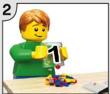 Lego figure assembling a 16-inch block with colorful bricks on a wooden table (no text or symbols visible)