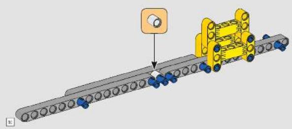 Mechanical assembly diagram showing a conveyor belt with blue spheres and a yellow cylindrical component, no text or symbols present.