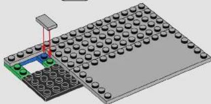3D diagram of a LEGO base with a green and black component, no text or symbols present