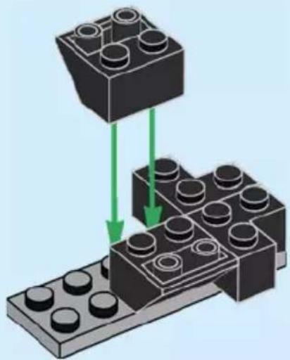 Diagram of two LEGO blocks with green arrows indicating movement or assembly (no text or symbols)