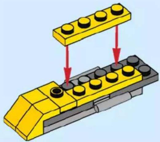 Diagram of a yellow LEGO base with black and gray components, showing a step and directional arrows (no text or symbols)