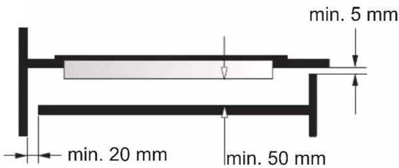 Technical diagram showing a hand holding a bent pipe with an arrow indicating compression, alongside an inset magnified view of a 2 mm measurement.