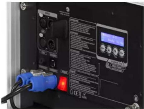 Close-up of a device control panel with labeled buttons, ports, and a red indicator light showing a warning symbol.