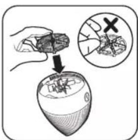 Diagram illustrating a hand holding a small object above a container with a magnified inset showing a close-up of a food item with an 'X' symbol.
