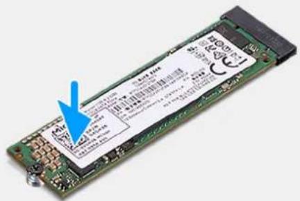 Electronic device with printed label showing technical specifications and a blue arrow pointing to a component.