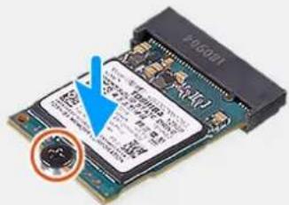 Close-up of a microprocessor or memory card with visible printed labels and a blue arrow pointing to a component.