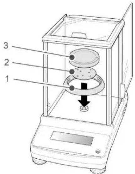 Diagram of a laboratory balance with labeled parts, showing internal components and a downward arrow indicating motion or force.