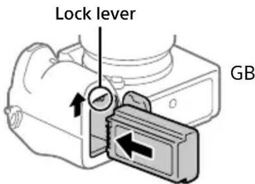 SONY Alpha ILCE-7RM4 - Insert the battery pack while pressing the lock lever with the tip of the battery until the battery locks into place. - 1
