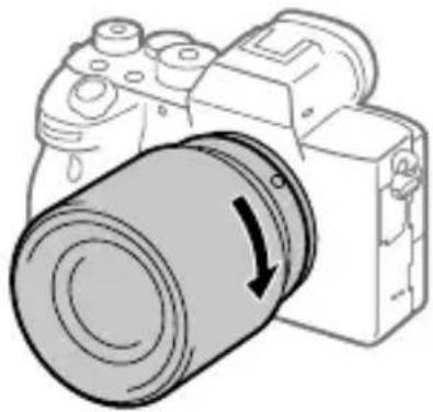 SONY Alpha ILCE-7RM4 - While pushing the lens lightly toward the camera, turn the lens slowly in the direction of the arrow until it clicks into the locked position. - 1