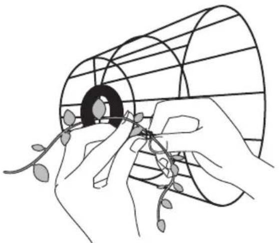 Line drawing of hands assembling a wire mesh with seedlings, no text or symbols present