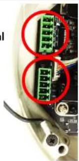 Close-up of electronic component with green and red circular annotations highlighting connector pins