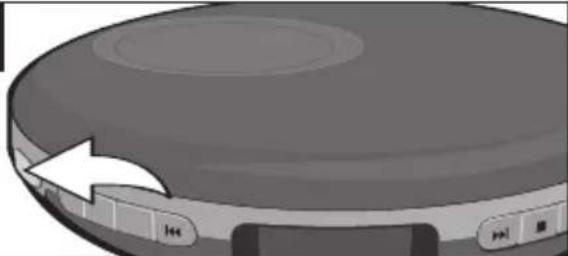 Close-up of a circular electronic device with a white arrow pointing to its side panel (no text or symbols visible)