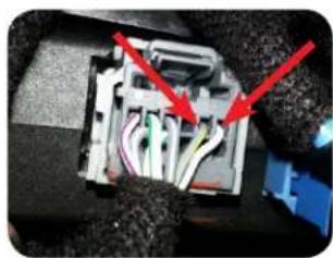 Close-up of an electrical connector with red arrows pointing to internal wiring (no text or symbols visible)