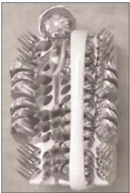Close-up of a decorative object with leaf-like patterns and a central vertical bar (no text or symbols visible)