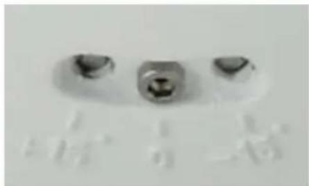 Close-up of three small metallic components with no visible text or symbols