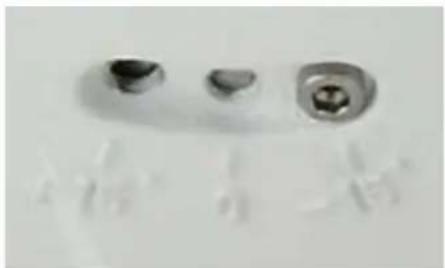 Close-up of three metallic dental crowns with no visible text or symbols