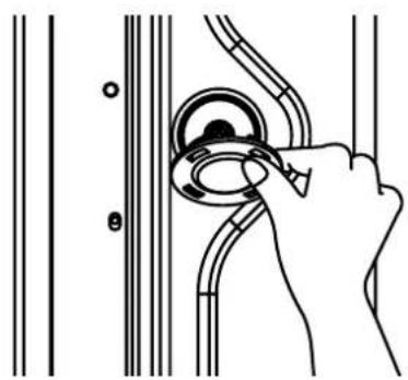 Line drawing of a hand adjusting a circular component between two vertical lines (no text or symbols)