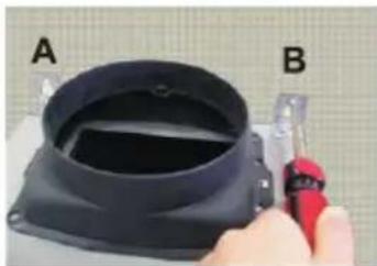 Close-up of a hand holding a tool next to a black plastic container labeled A and B (no text or symbols on the device itself)