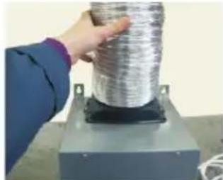Person holding a coiled metal wire on a mechanical base (no visible text or symbols)
