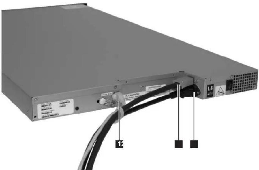 Diagram of a server rack with labeled ports and cable connections, showing warning labels and warning symbols