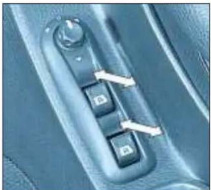 Close-up of a car's side panel with three buttons and a handle, no visible text or symbols