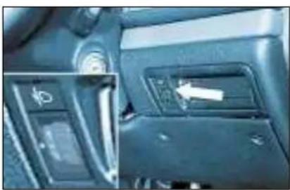 Interior view of a car dashboard with control panel and directional arrow (no visible text or symbols)