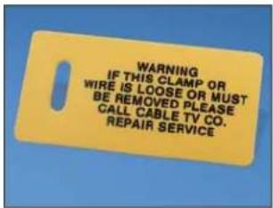 WARNING IF THIS CLAMP OR WIRE IS LOOSE OR MUST BE REMOVED PLEASE CALL CABLE TV CO. REPAIR SERVICE