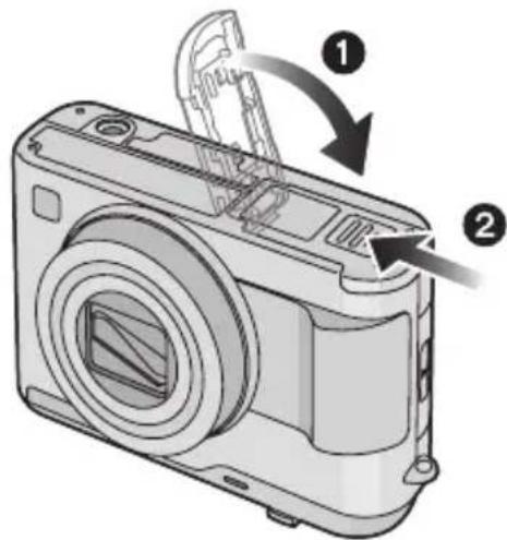 Diagram of a digital camera with labeled parts and directional arrows indicating assembly or operation.
