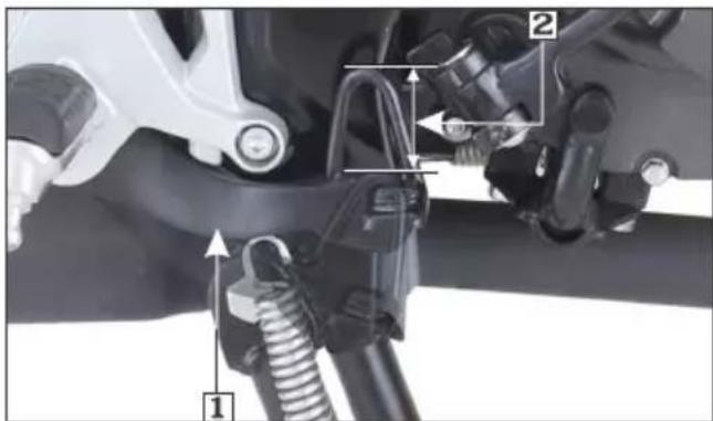 Technical diagram showing mechanical components with numbered labels 1 and 2 indicating parts of a vehicle or system assembly.