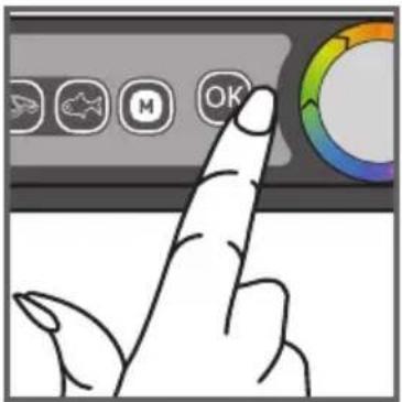 Hand pointing at a control panel with icons for navigation, battery, mouse, and OK button
