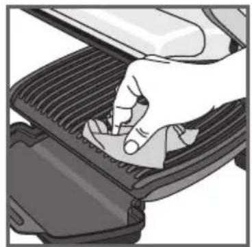 Hand pressing down on a mechanical component with a tool (no visible text or symbols)