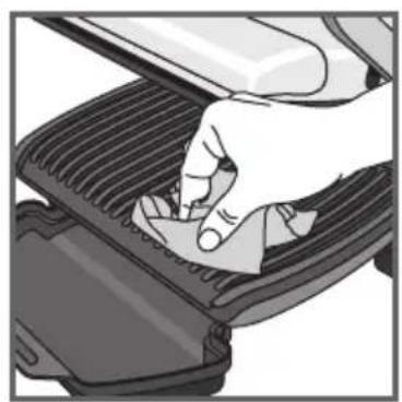 Hand pressing down on a mechanical component (no text or symbols visible)